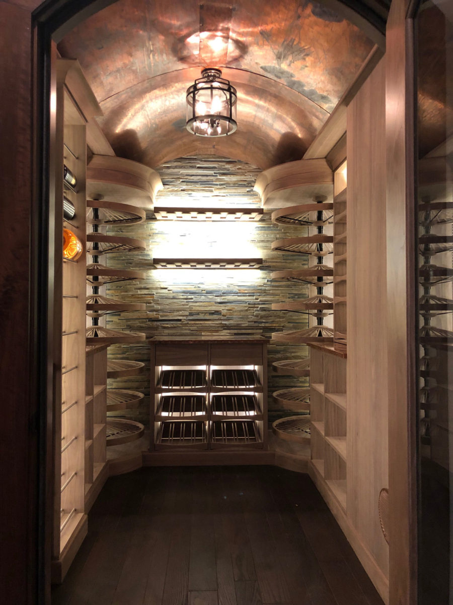 wine cellar crafted in walnut with copper patina ceiling and countertops