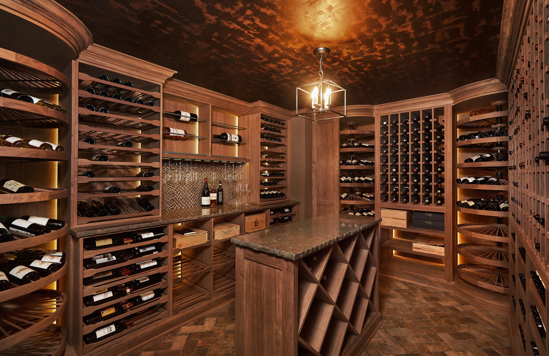 Custom dramatic rich Walnut wine cellar with center island and counter area for tasting