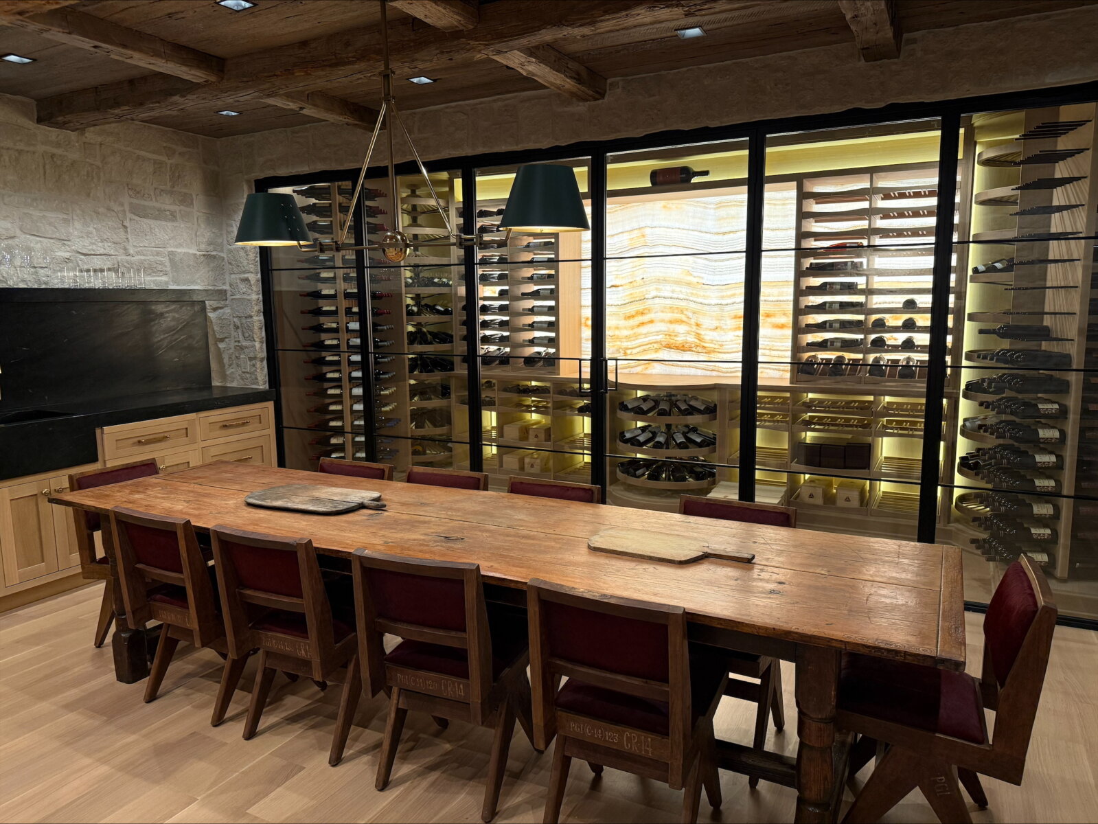 Views into glass enclosed wine cellar from dining room, steel framed glass doors and decorative backsplash