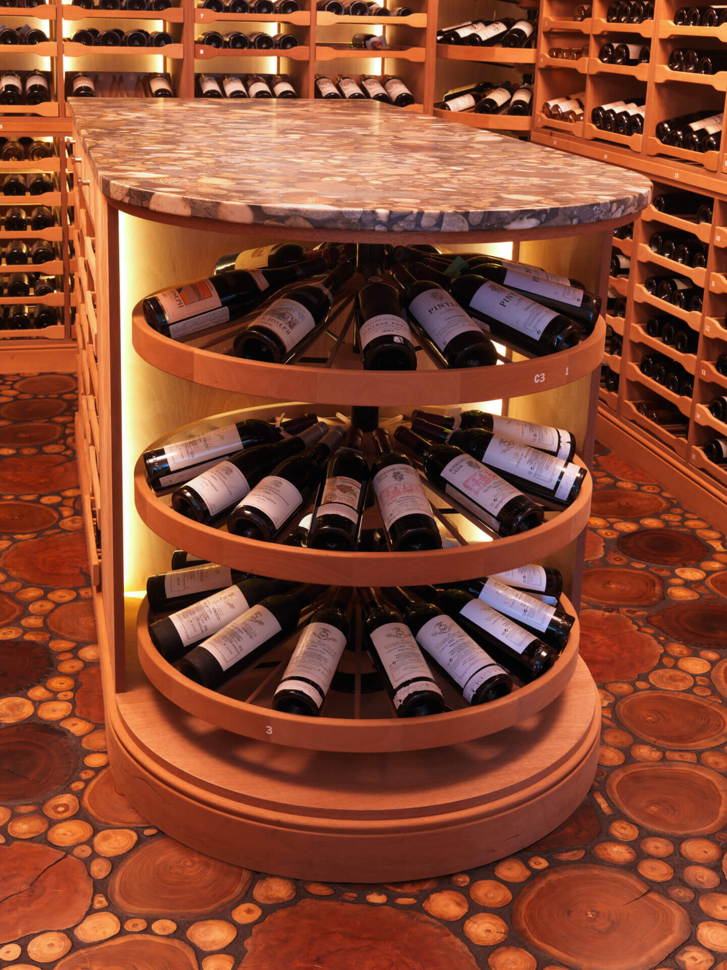Counter-height Wine Wheel rotating wine storage built into a cellar island