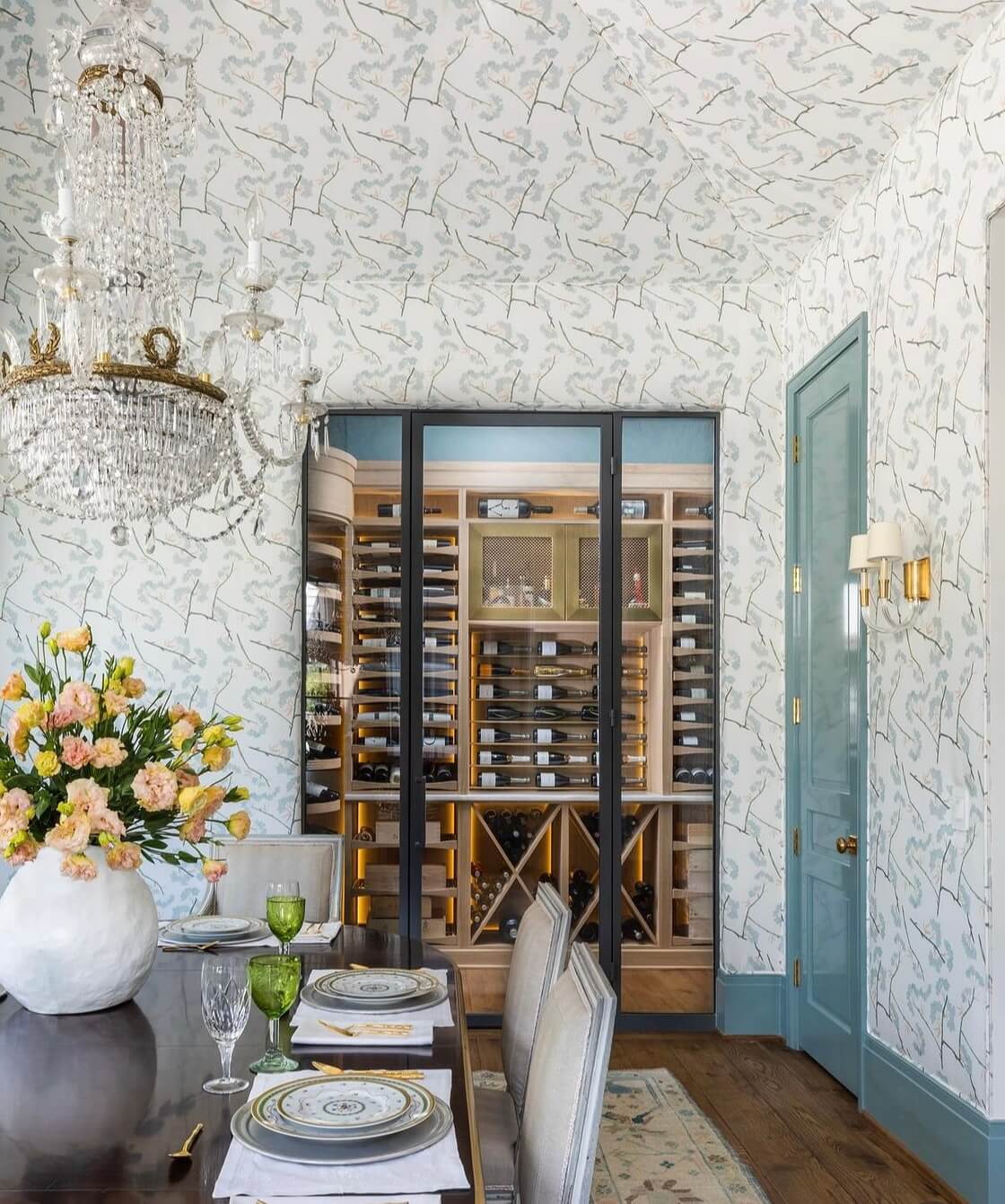 Glass-enclosed wine cellar with custom wood wine racks, LED lighting, and luxury dining room design
